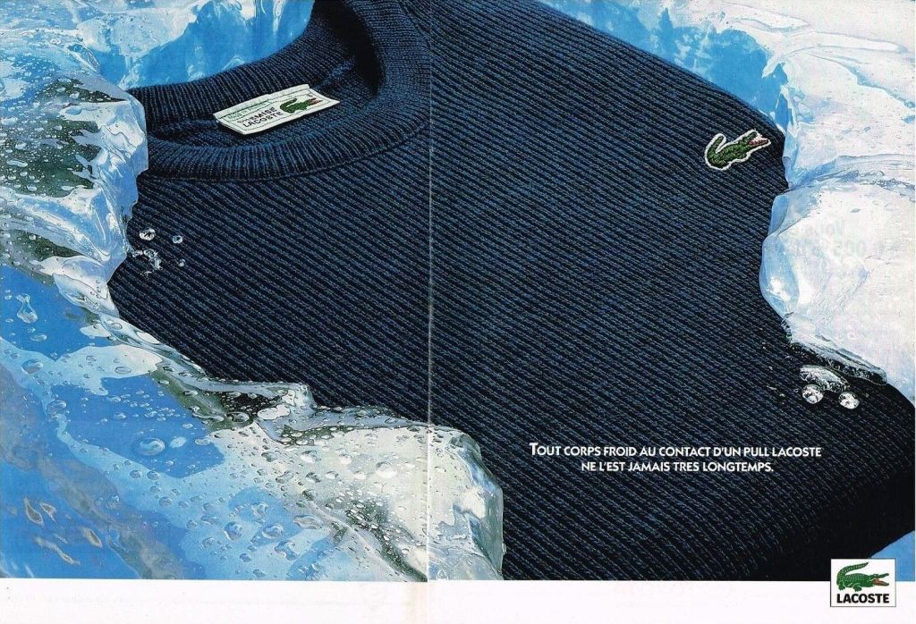 Publicité Lacoste - Double page - Couleur - Pull bleu marine - Tout corps froid au contact d'un pull Lacoste, ne l'est jamais très longtemps - 1991