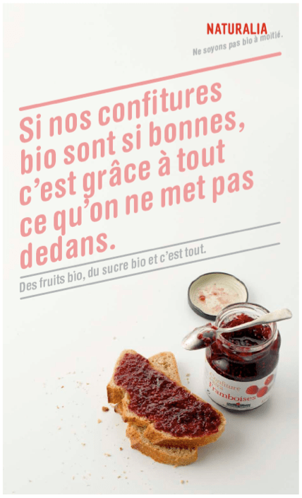 Publicité Naturalia - Ne soyons pas bio à moitié - Agence Leg - 2008-2010 - Si nos confitures sont si bonnes, c'est grâce à tout ce qu'on ne met pas dedans - Pot de confiture ouvert, tartine de confiture - fond blanc