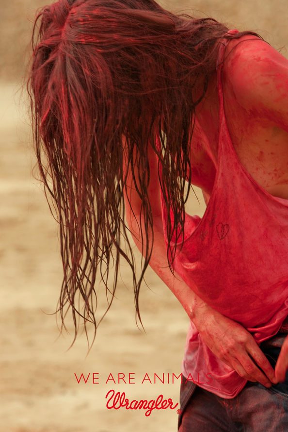 Publicité Wrangler - We are animals - Red - Une femme avec un tee-shirt très échancré s'affaire autour de sa poche - Agence Fred&Farid - France - 2010 - Photo Jeff Burton