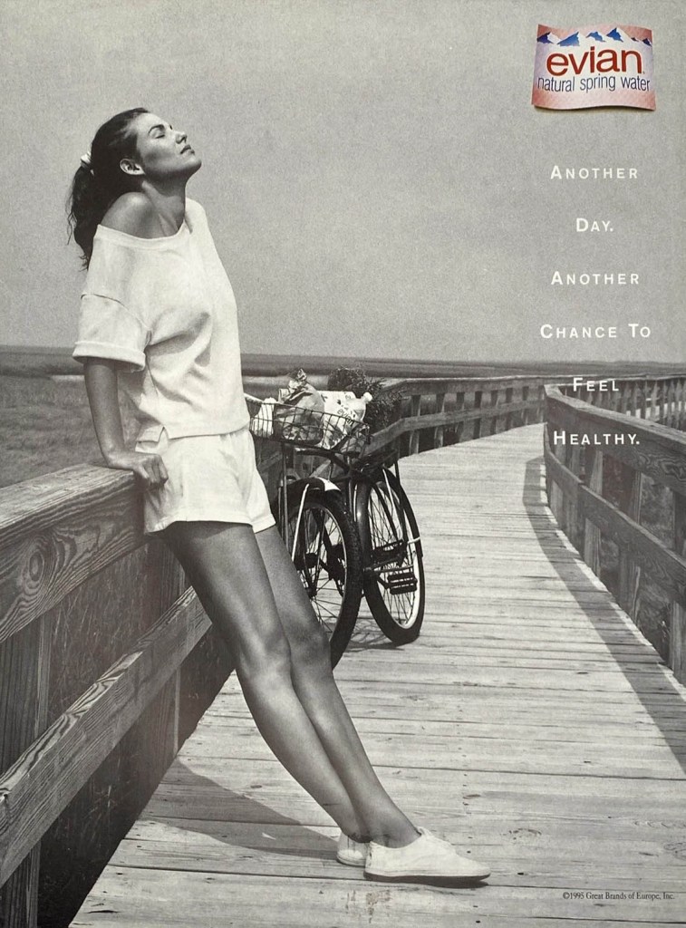Publicité evian - USA - Another day. Another chance to feel healthy - Une femme semble se reposer sur un ponton à côté de son vélo - 1995