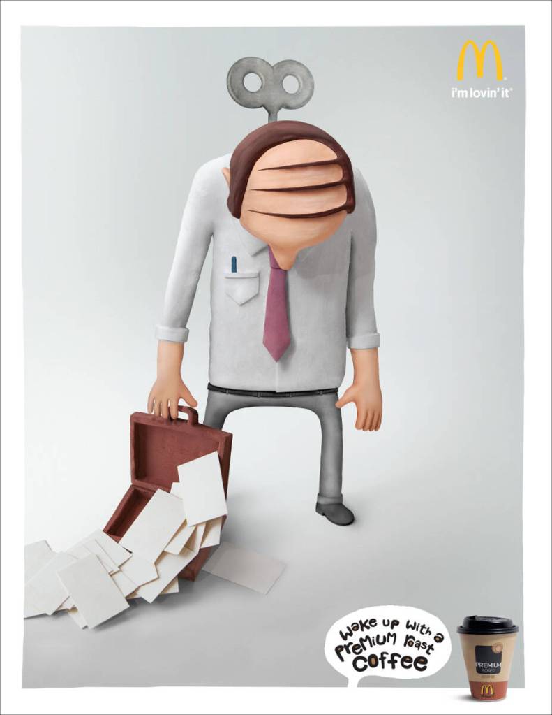 Publicité McDonald's - Wake-up with a premium roast coffee — Un employé de bureau totalement endormi - Clé dans le dos - Agence Alma DDB - USA - 2008