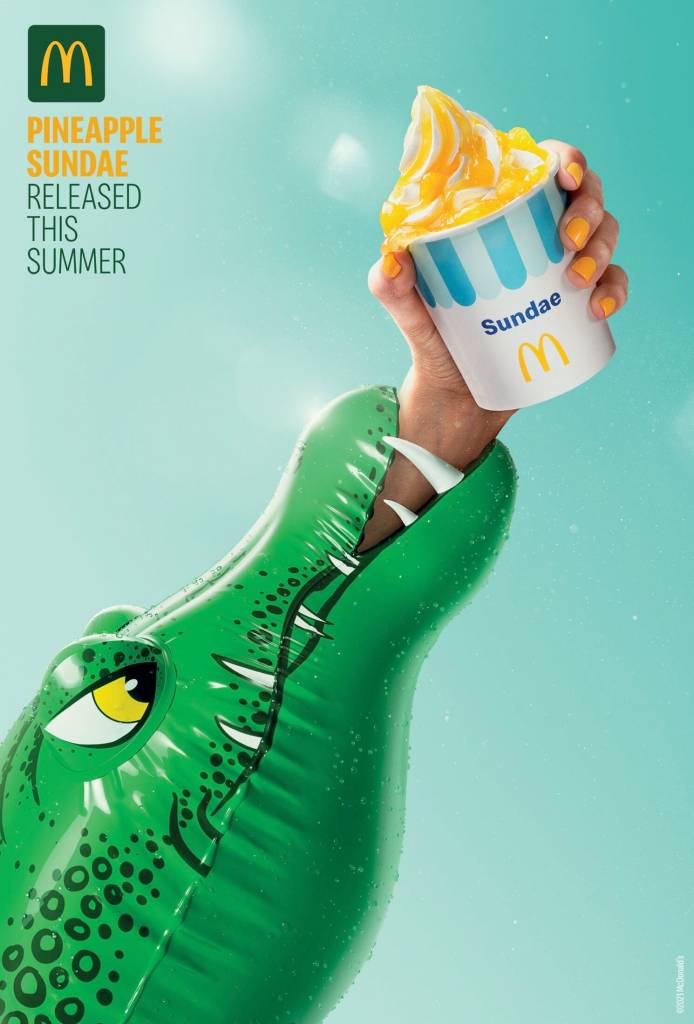 Publicité McDonald's - Desserts - Released this summer - Crocodile gonflable mord un bras qui tient un Pineapple Sundae -TBWA - Portugal - 2021